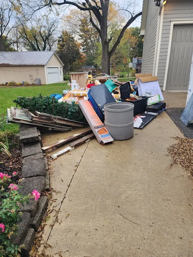 Dumpster being loaded with debris for Roofing Dumpster Rental in Green Oak